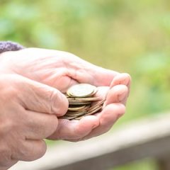 Money, coins, the grandmother on pensions and a concept of a living minimum - in hands of the old woman isn't enough money.